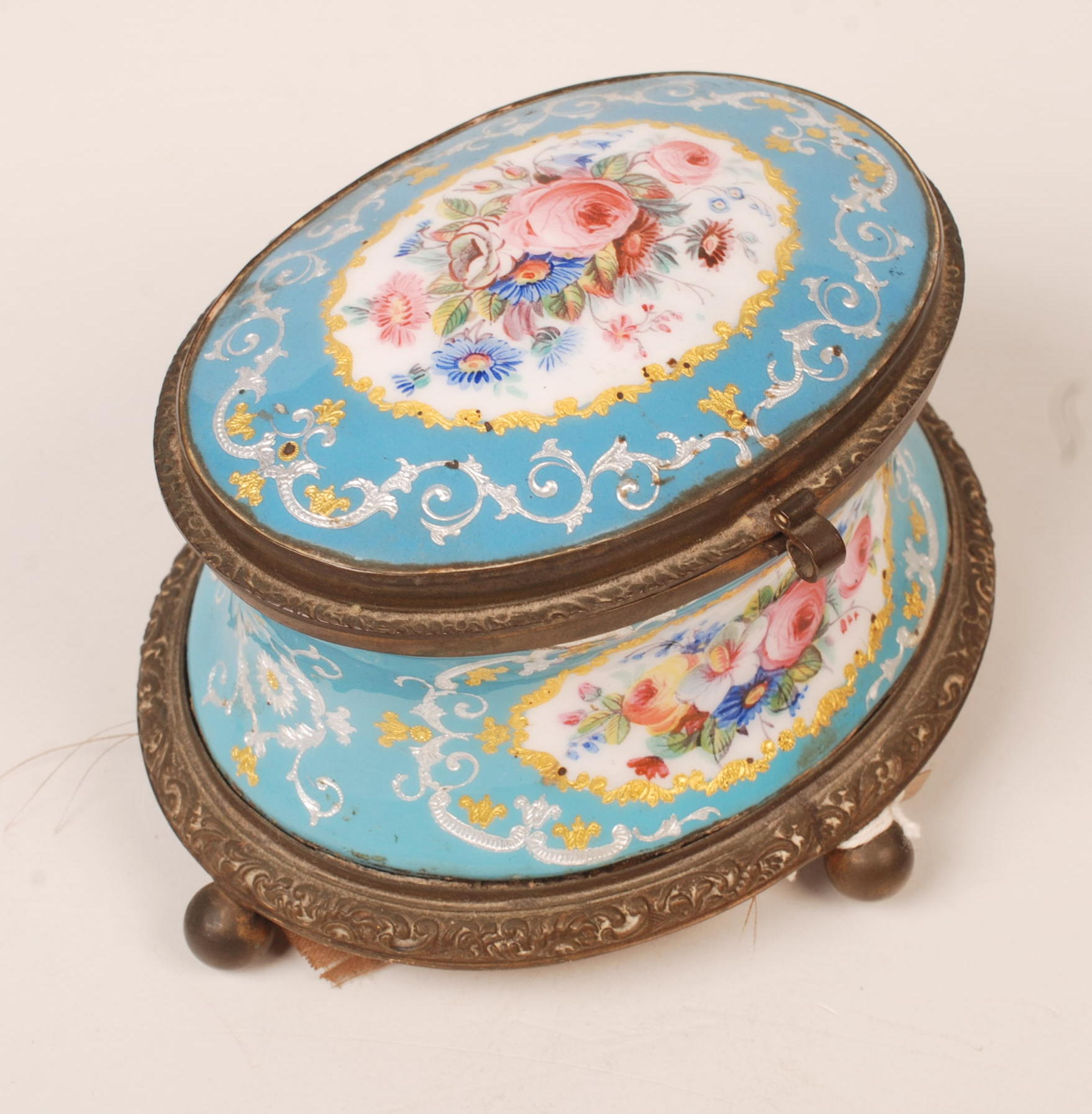 A pale blue ground French enamelled jewel casket painted with floral groups and gilding.  Lacks