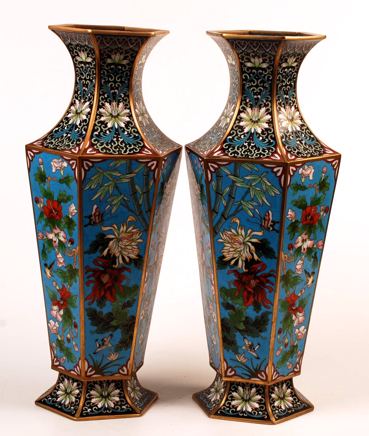 A pair of Chinese Republic hexagonal section cloisonne vases, each gilt and with blue ground