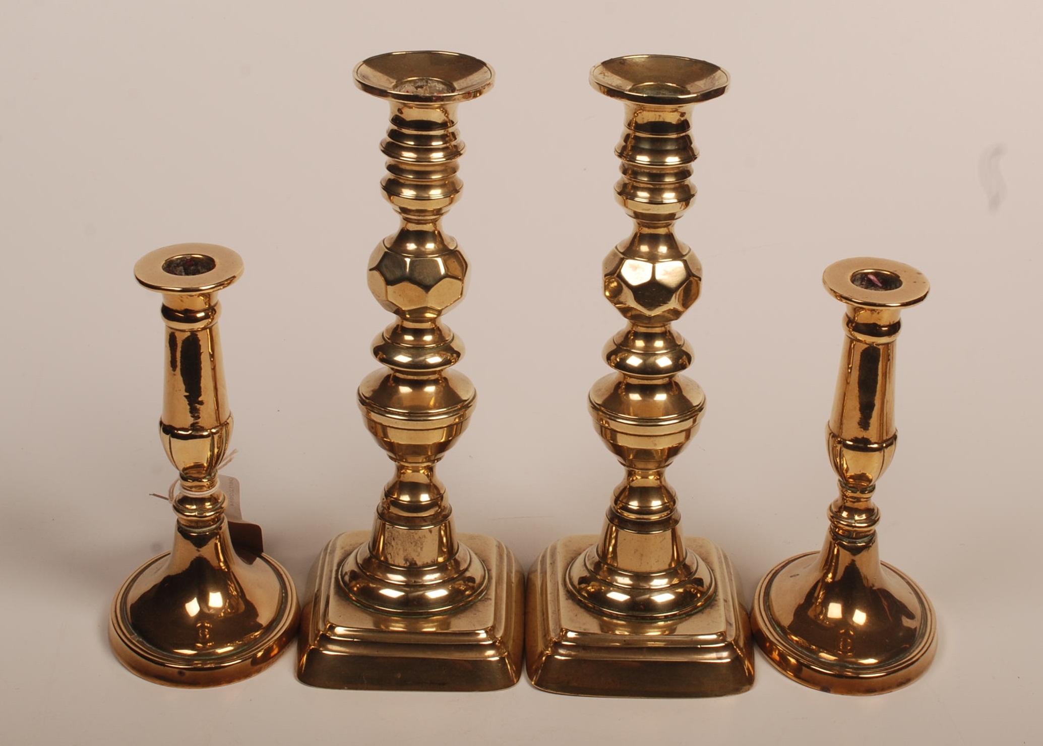 Two pairs of brass candlesticks.