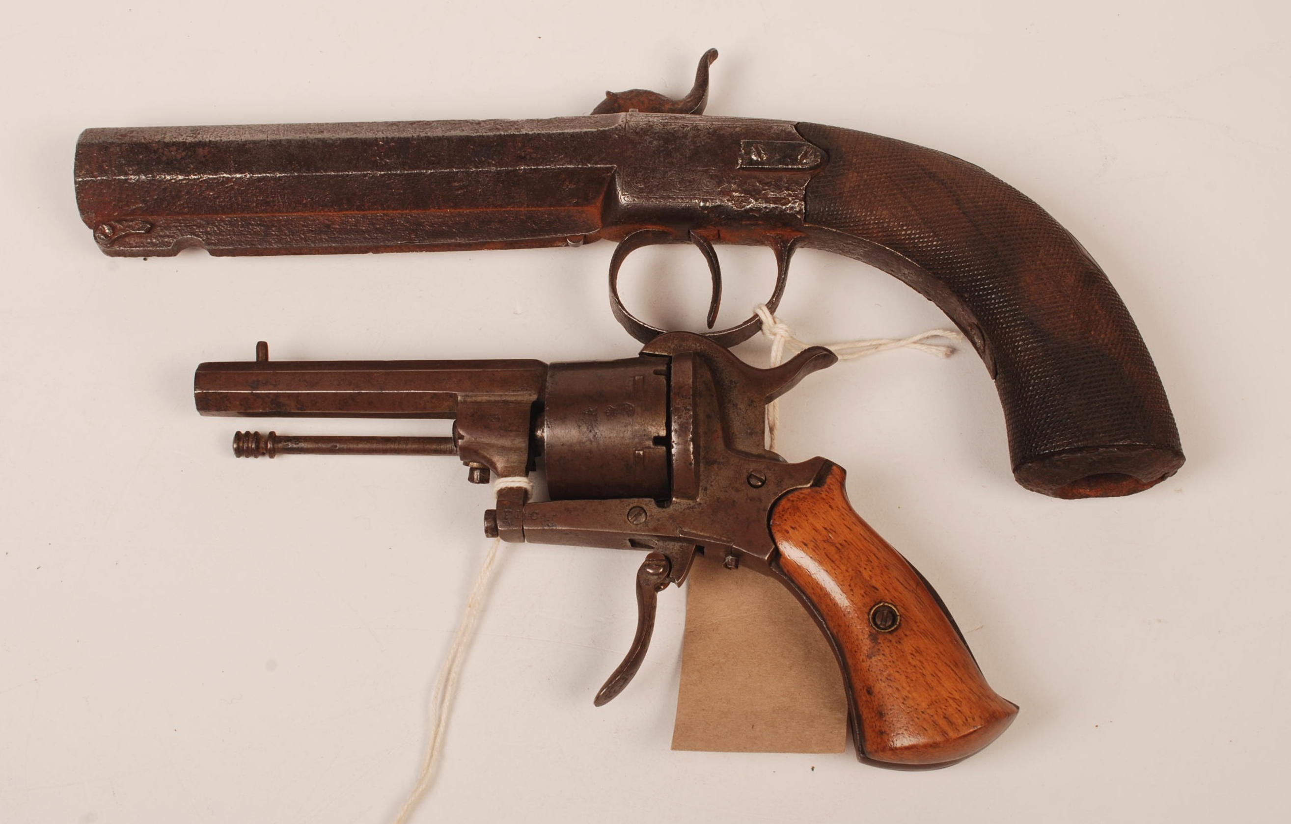 A 19th century percussion cap pistol with an octagonal barrel and hatched walnut grip, originally
