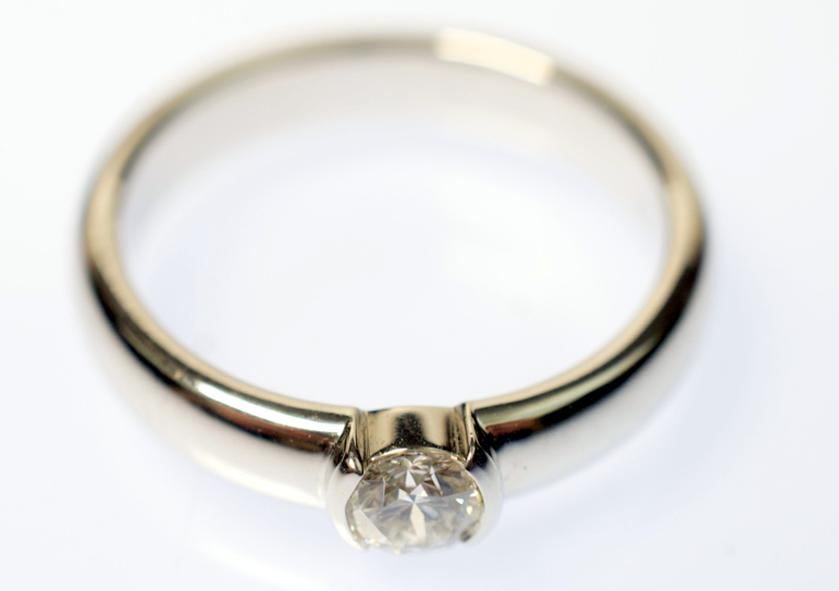A platinum solitaire ring by Tiffany & Co., the stone measuring 0.27ct., clarity grade VS1, sold