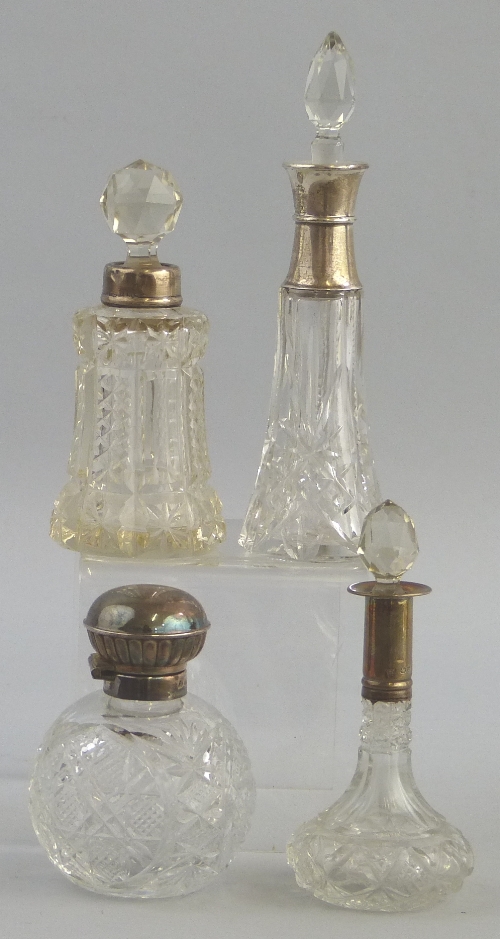 A cut glass scent bottle, of circular tapering form with faceted replaced stopper in girdled silver