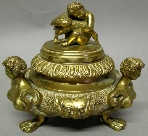 A Continental brass bowl and cover, of flattened circular form cast with three caryatid figures and