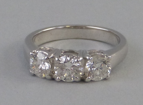 A three stone diamond ring, the three stones (1.80ct) claw set on an 18ct white gold shank, size