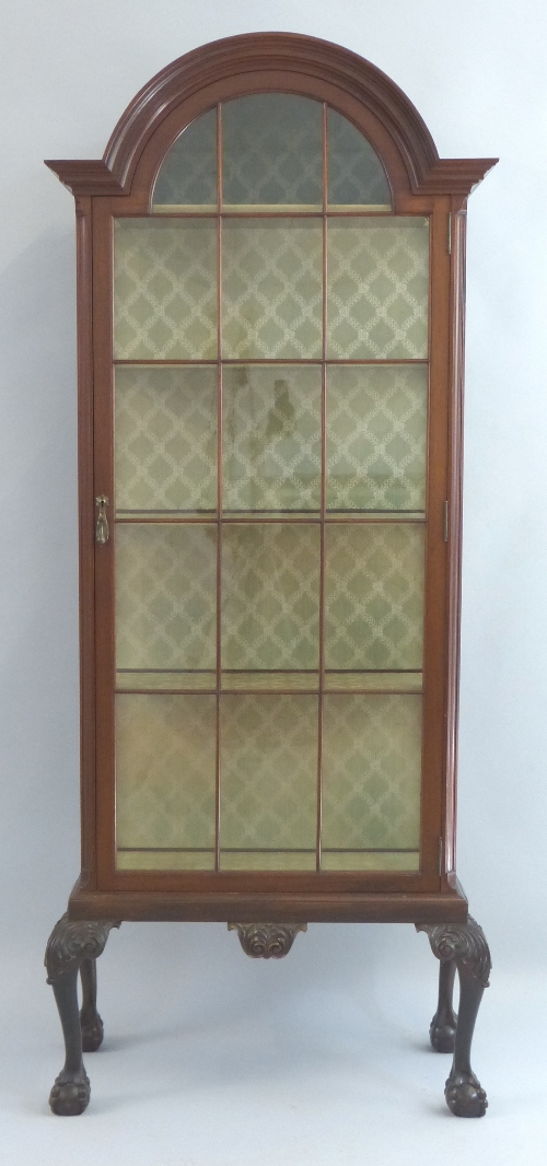 A 20th Century mahogany display cabinet, the arched top with flared cornice over astragal glazed