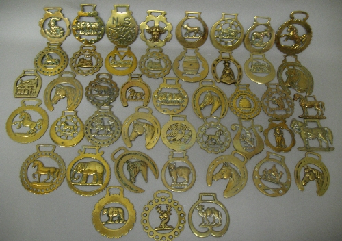 Forty four Victorian and later horse brasses, depicting horses and other animals including