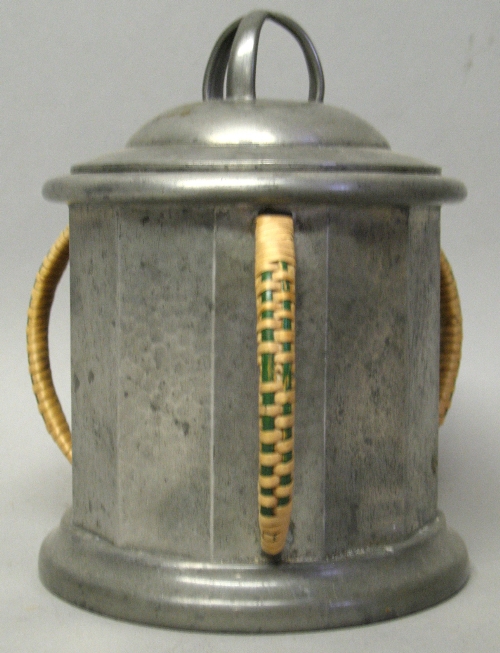 A Civic Pewter Arts & Crafts style biscuit barrel, of beaten twelve sided form with three cane