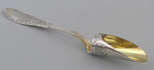 A 19th Century American stilton scoop, the gilded scoop bright cut and chased with stylized