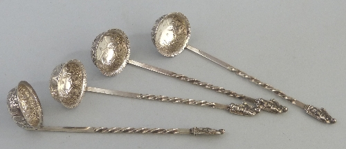 A set of four Victorian Scottish spirit ladles, having scroll and flowerhead embossed circular