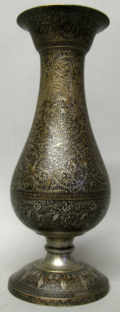 An Indian Bidri Ware vase, of baluster form with pedestal base and trumpet rim and all over