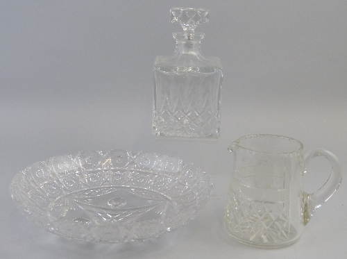 A clear glass decanter, of cuboid form with deep cut body, star cut base and matching square