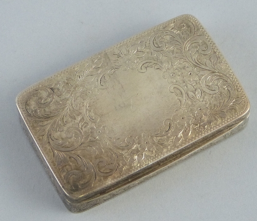 An Edwardian snuff box, of rounded oblong form, the hinged lid with blank cartouche on a chased and