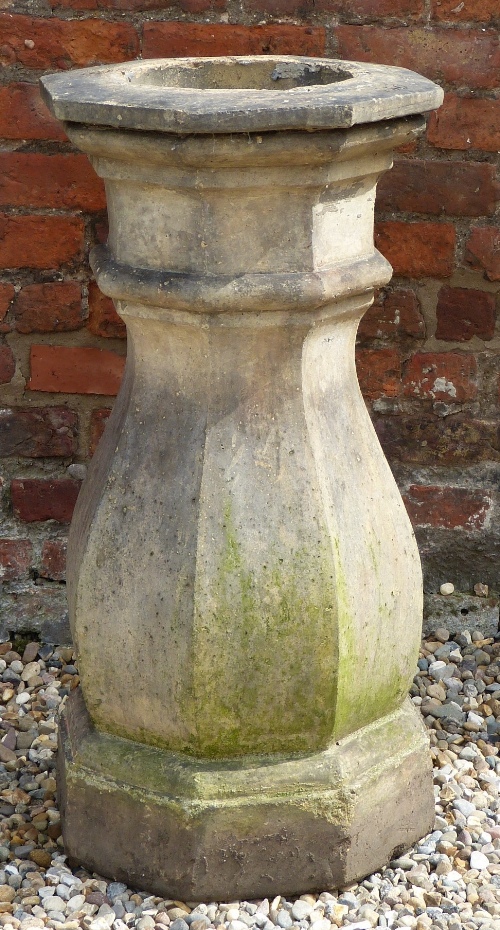 A Victorian composition stone chimney pot, of faceted baluster form with octagonal top and base,