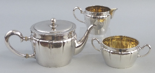 A WMF three piece tea set, the circular teapot with flower finial on slightly domed hinged lid,