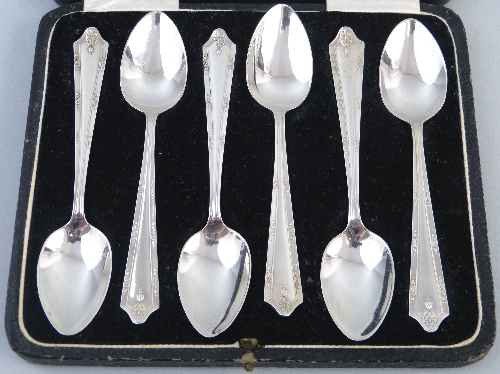 A set of six teaspoons, the tapering hafts moulded with hair bells and stylised flowerheads, in