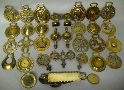 Twenty two Victorian and later horse brasses, and ten horse harness brass mounts, including