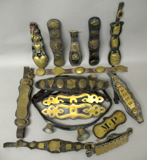 Fifteen Victorian and later leather mounted horse harness brasses, including makers Nelson Malton,