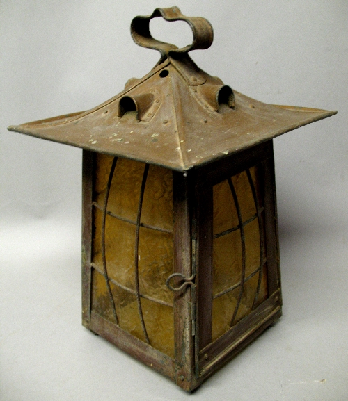 An Arts & Crafts coppered lantern style ceiling light shade, of tapering square form, the caged