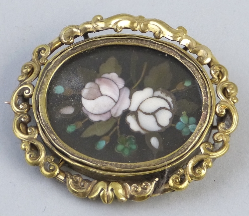 A Pietra Dura brooch, of oval form depicting roses and foliage within a scrolling yellow metal