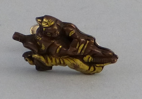 A Japanese parcel gilt bronze cuff link or button hole pin, as a crouching samurai warrior with