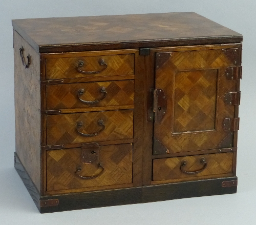 A late 19th/early 20th Century Japanese oak parquetry table cabinet, of oblong form, the lift off