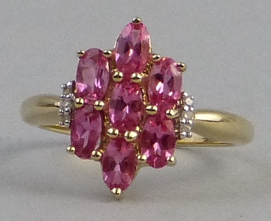 A noble red spinel cluster ring, comprising seven oval stones set with diamonds on 9ct gold shank,