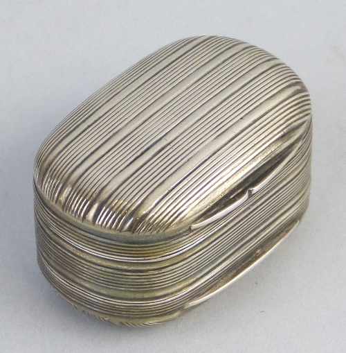 A George III nutmeg grater, in the form of a double sided rounded oblong box, reeded all over, the