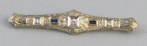 An Art Deco style diamond and sapphire bar brooch, comprising three circular diamonds divided by