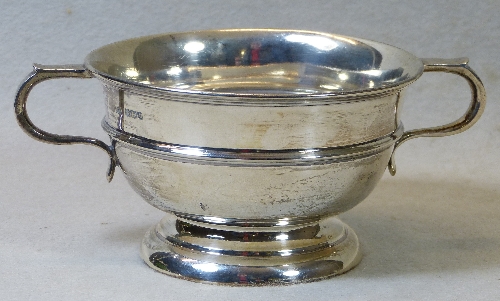 A presentation sugar bowl, of circular form with twin flattened scroll loop handles, the girdled