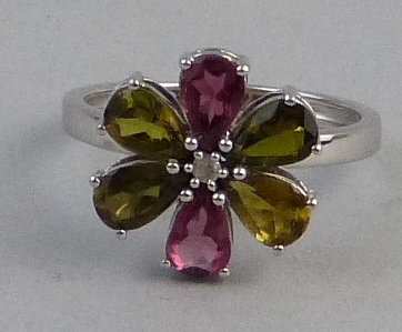 A tourmaline and diamond ring, comprising pink, yellow and green tourmaline surrounding a diamond