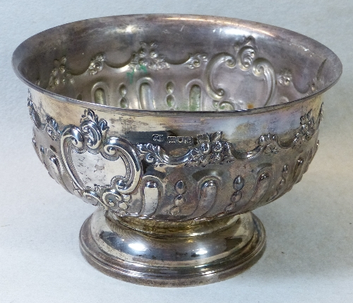 A late Victorian rose bowl, of circular form embossed with scrolling blank cartouche on semi