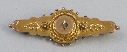 A late Victorian 9ct gold bar brooch, centrally set with a small diamond within a rope twist and