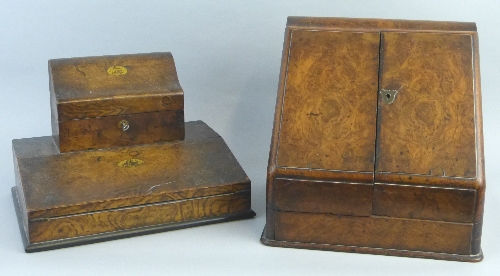 An early 20th Century burr walnut stationery cabinet, with hinged serpentine top, sloping front with