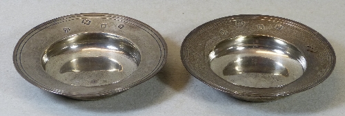 A pair of bon bon dishes, in the form of circular alms plates with line incised flared rim, 11.5cm