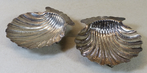 A Victorian butter dish, in the form of a scallop shell with crested lug handle raised on three