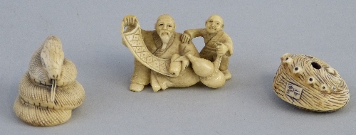Three Japanese ivory netsukes, seated man unfurling a scroll with a boy holding a gourd by his side,