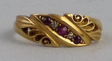 An Edwardian ruby and diamond ring, in the form of an 18ct gold band moulded with leaves and scrolls