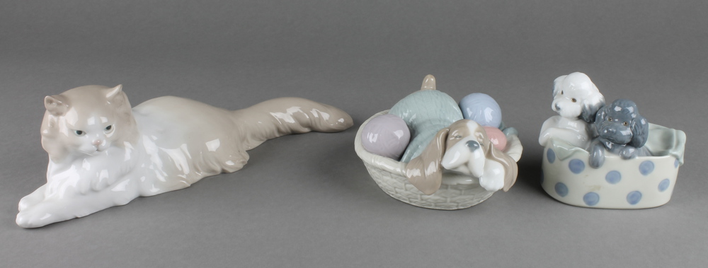 3 Nao figures, a reclining cat 11"", 2 puppies in a box 4"" and a puppy in a basket 5
