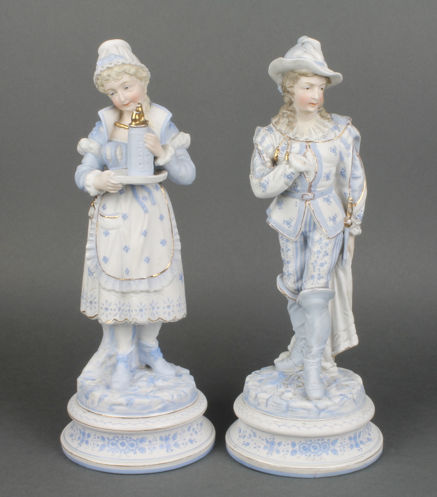 A pair of 19th Century German bisque figures of a lady and gentleman on raised rustic bases 12""