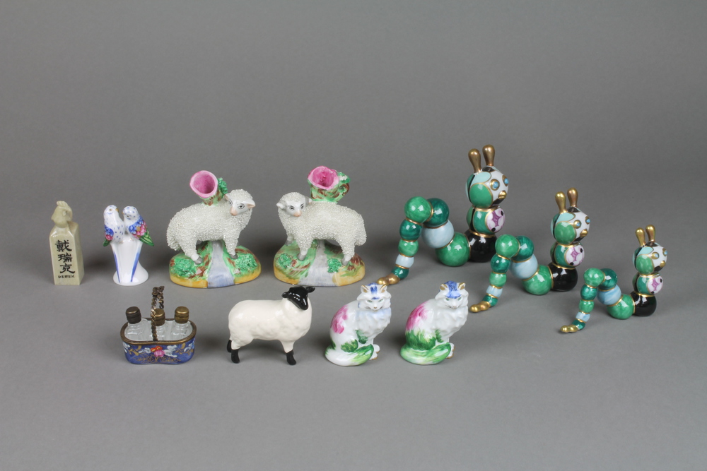 A pair of reproduction Staffordshire figures of sheep 3"", a Beswick lamb 2 1/2"" and minor