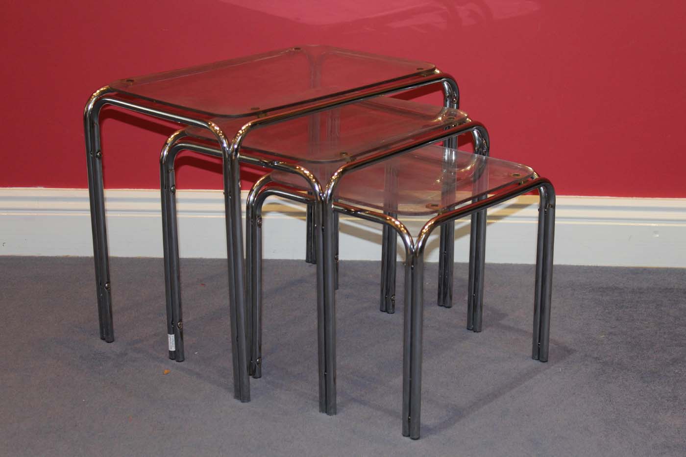 A NEST OF CHROME AND PERSPEX TABLES, 
Maximum 46 x30cm