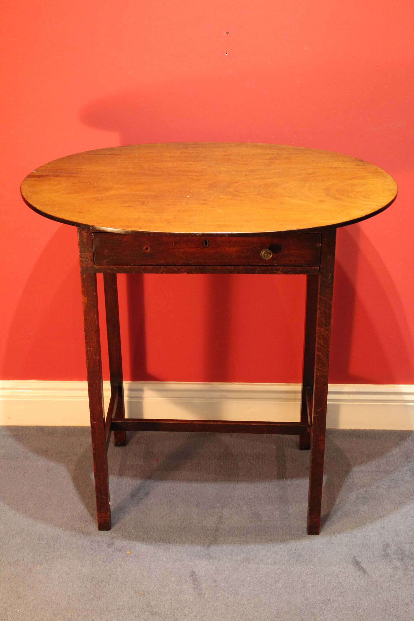 A MAHOGANY CHAMBER TABLE, c,1800 with oval top with one frieze drawer on square legs. 71cm high x