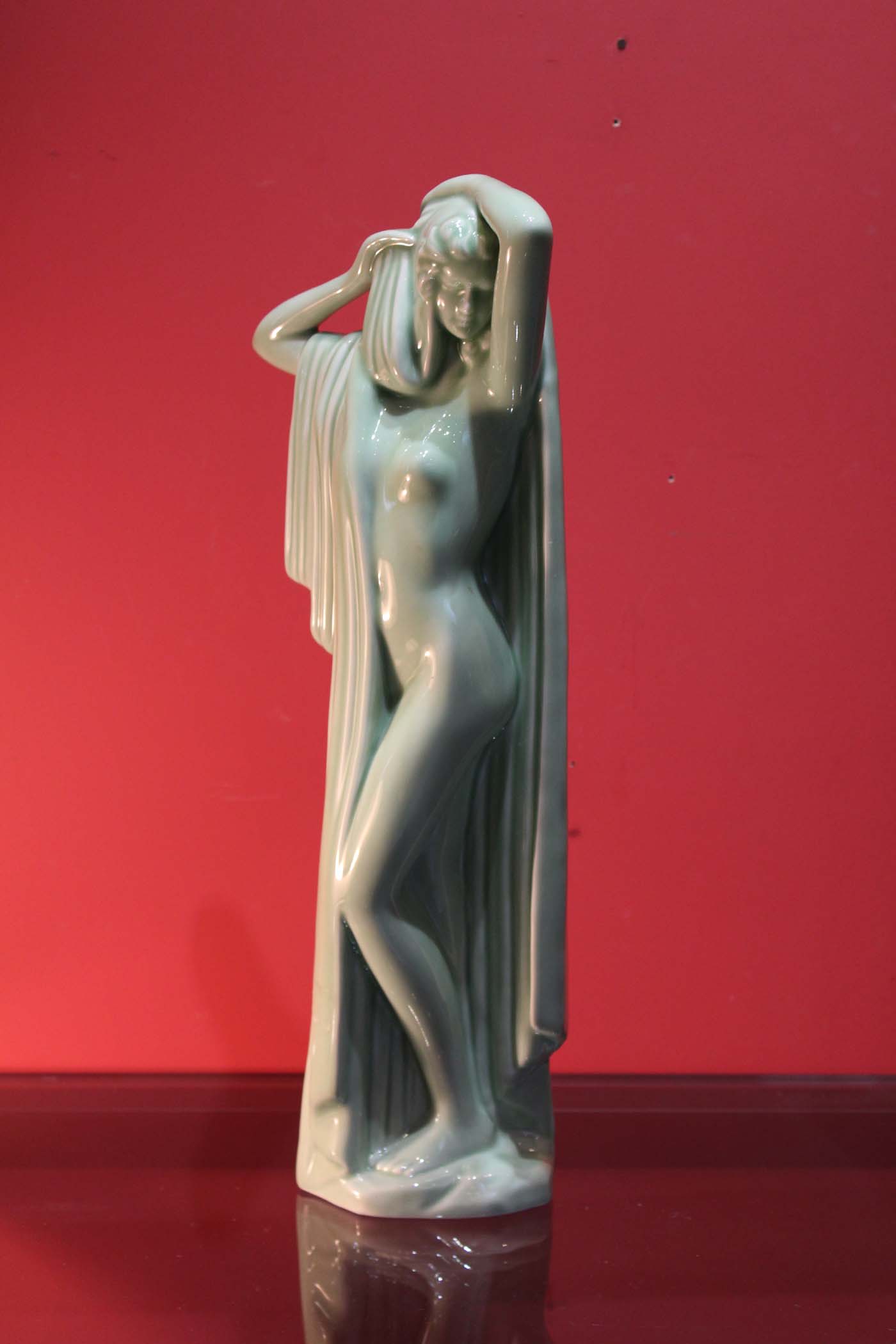 AN ART DECO PORCELAIN STATUE OF A LADY, 19  1/4" high (49cm).