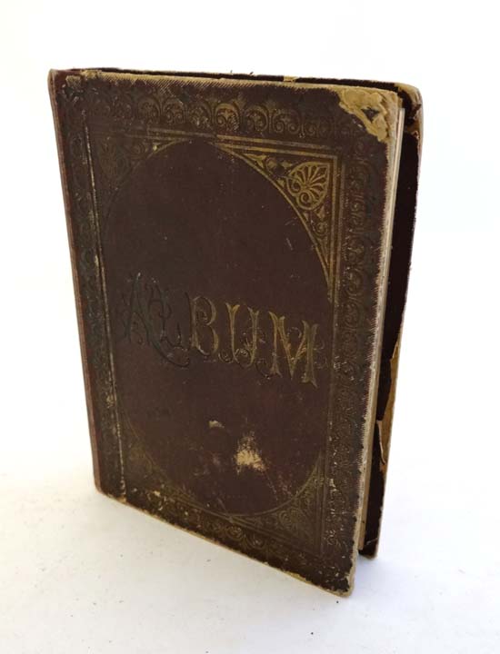 Album : A small cloth bound late Victorian photograph album containing 12 portrait photographs . 5 x