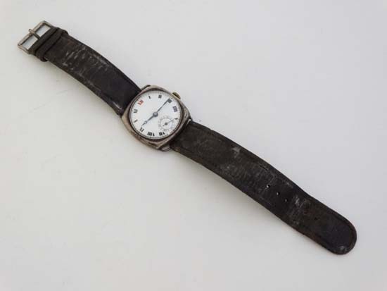 Gents Silver Watch : an early imported silver Swiss wristwatch with a circular white enamel dial