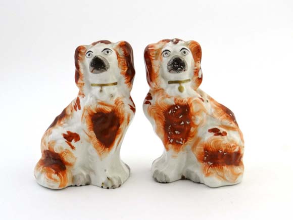 A pair of Victorian Staffordshire Spaniels decorated in iron red and wearing gilt collars. Height