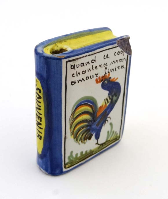 A novelty Quimper flask in the form of a book marked 'Quand ce coq chantera mon amour finira' (