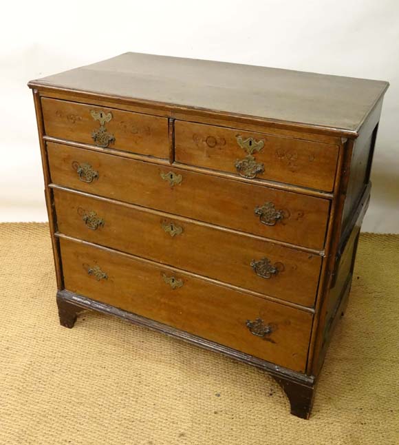 An early 18th oak chest of drawers comprising 2 over 3 graduated long drawers,  cock beaded sides