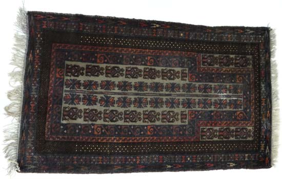 Rug Carpet : An Afghan Beluch pray rug , the ivory mehrab with stepped medallions and three guard
