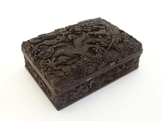 Early 20th century Chinese deeply carved black cinnabar lacquer box depicting dragon and phoenix